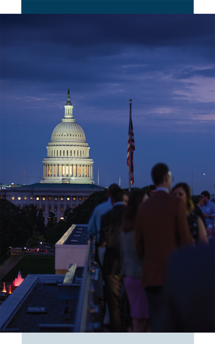 US Capital with US flag and professional outdoor networking event at night